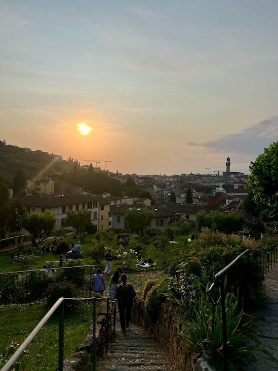 People gather in a park a mile from the city center of Florence, Italy to watch the sunset.