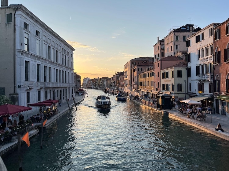 waterway in Milan, Italy where a boat is driving through