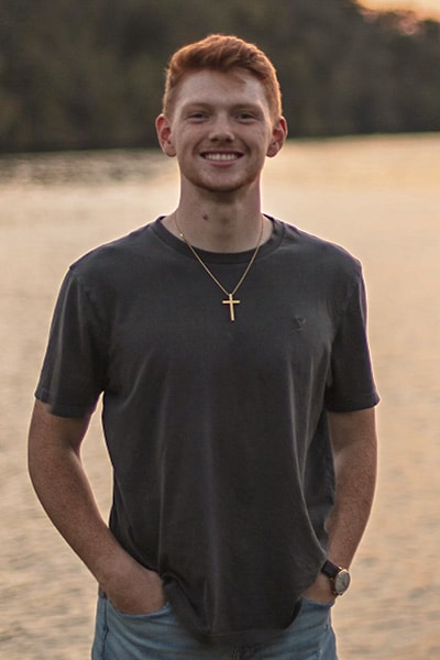 John Helphinstine standing in front of a lake