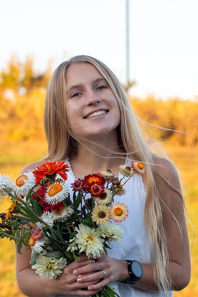 Jordan Wetzel holding a bouquet of flowers