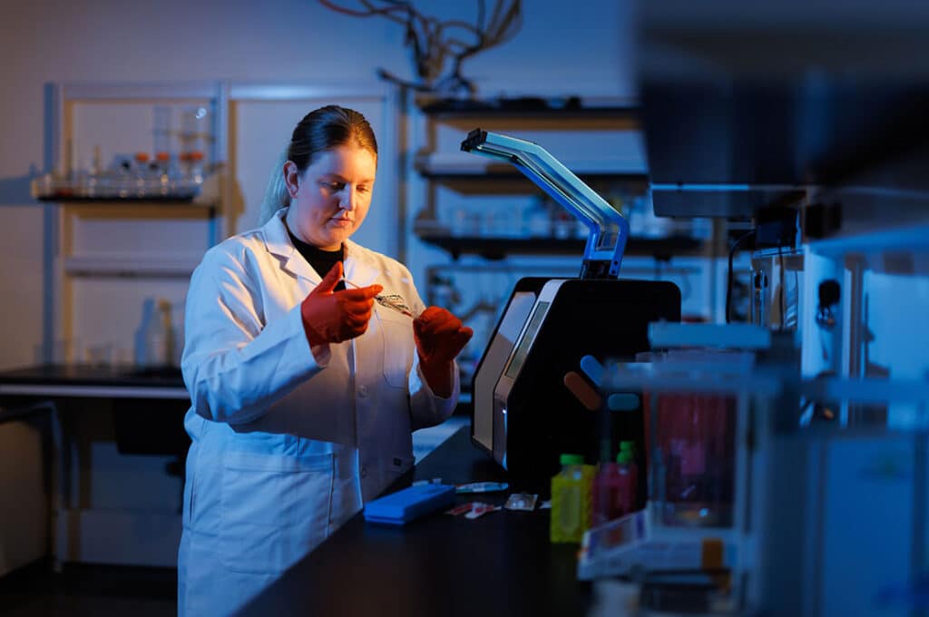 Alumna Natalie Gosnell (BS biomedical engineering ’19, MBA ’23) works in an Orion Therapeutics pharmaceuticals lab in the Institute for Advanced Materials and Manufacturing