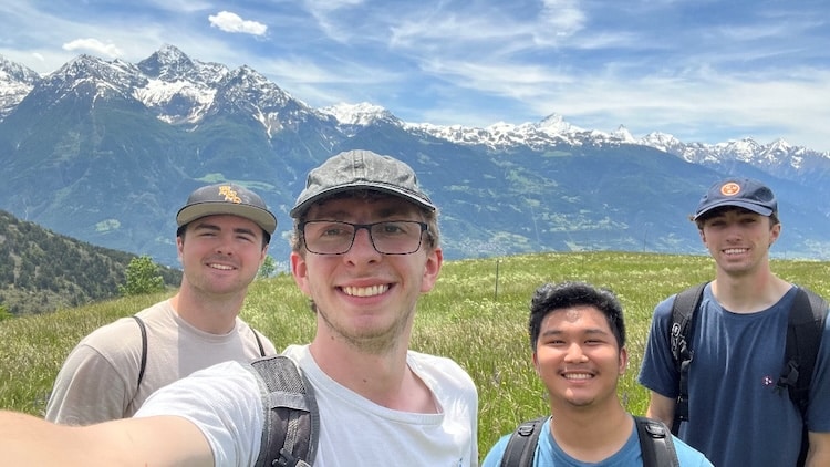 Wesley Shannon and friends hiking with a mountain in the background