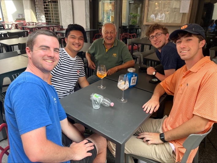 Will Locke and his friends eating at a restaurant in Milan
