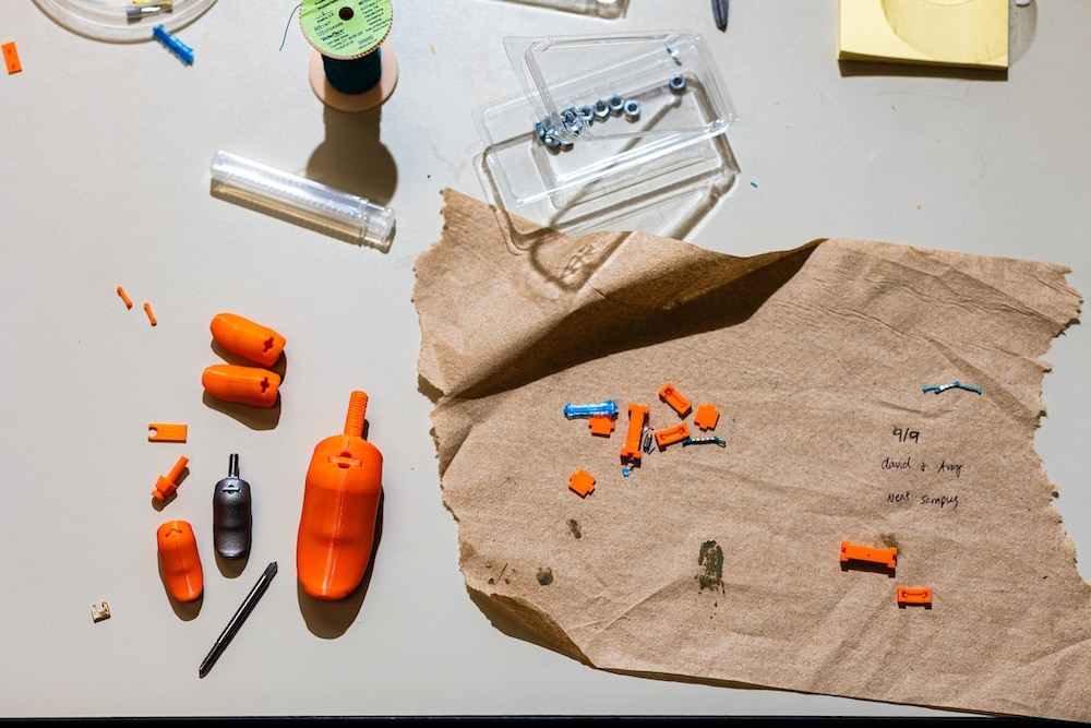 pieces of a prosthetic thumb laid out on a table