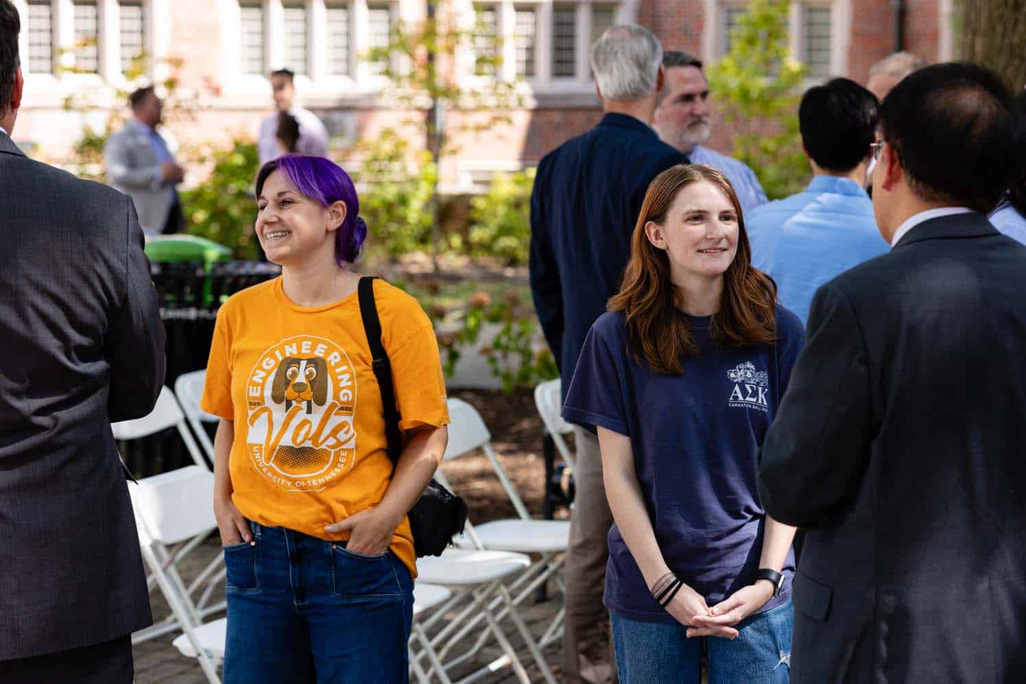 Students speak with Dacheng Ren and Matthew Mench after the ribbon cutting ceremony.