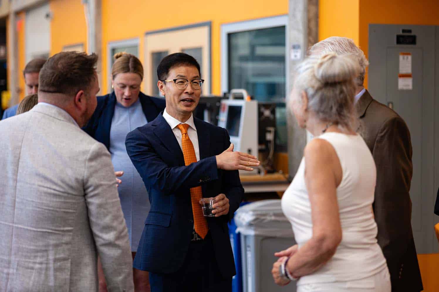 Chulho Yang speaks with guest during the Applied Engineering ribbon cutting ceremony.