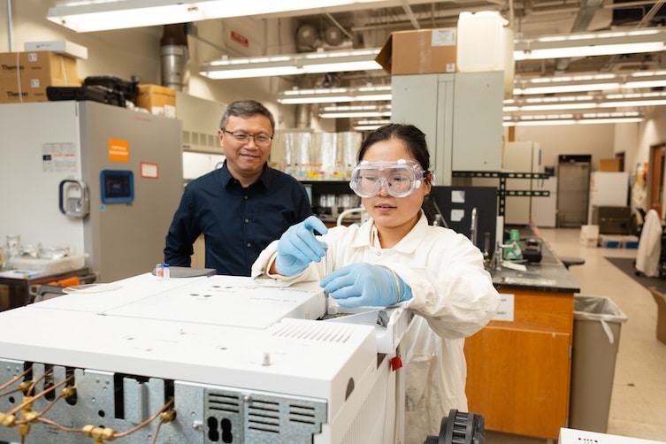 Qiang He and graduate student working in the lab