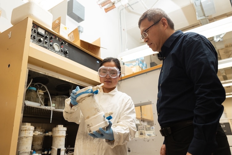 Qiang He and a graduate student in the lab