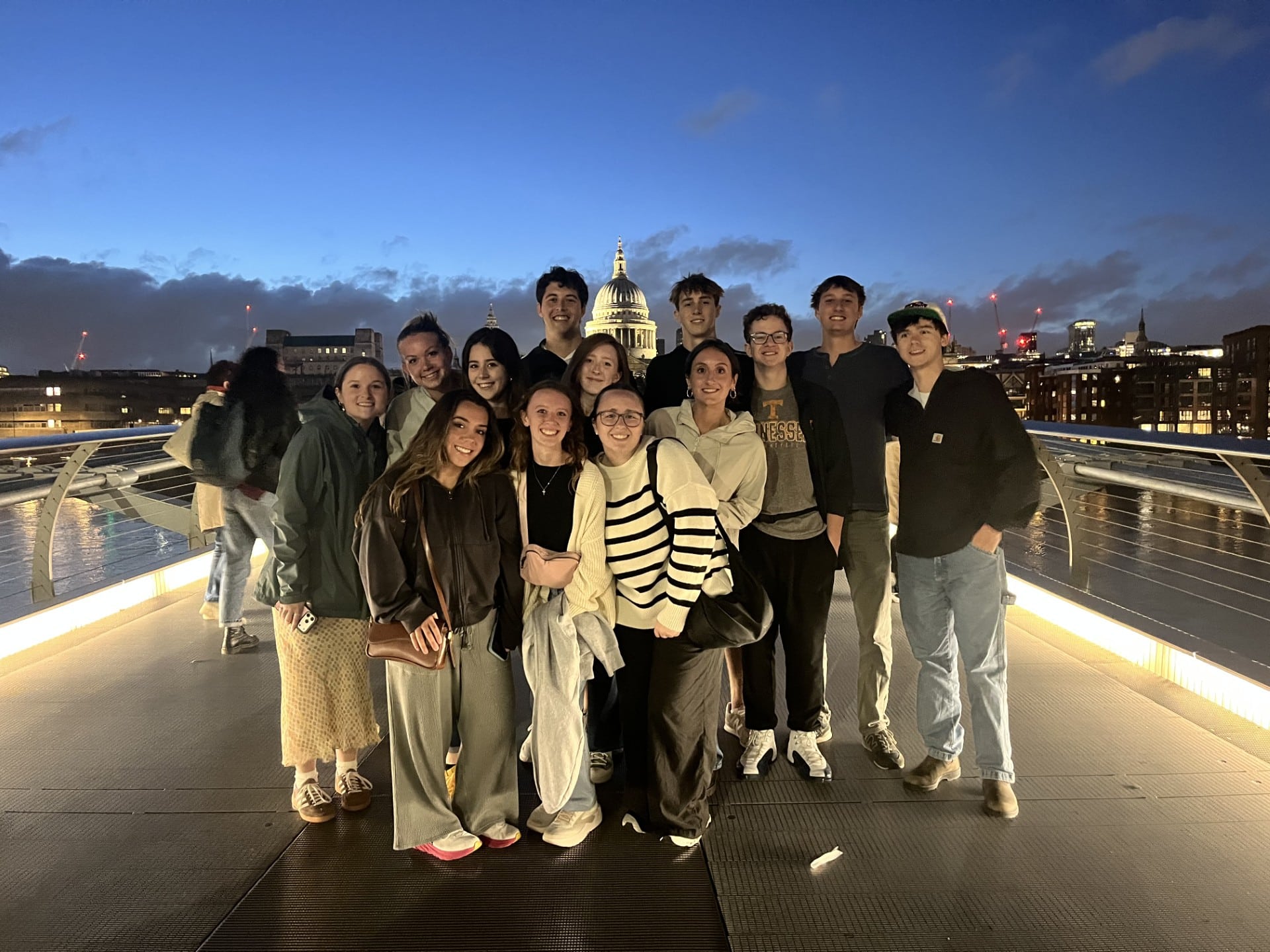 Hadley Lorr and fellow study abroad students posing at dusk with a government building behind them