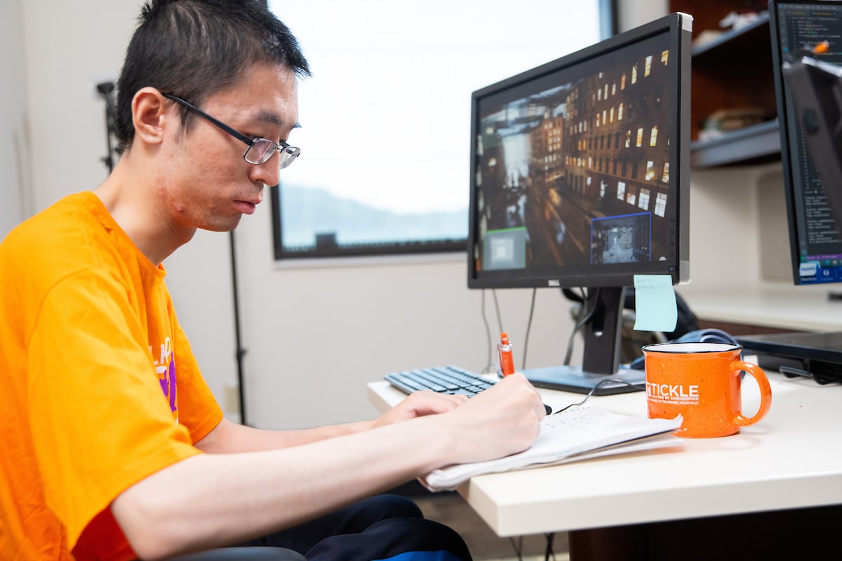 Graduate student Songyang Liu uses a simulator to test his drone delivery for wheelchair systems software in the John D. Tickle Engineering Building