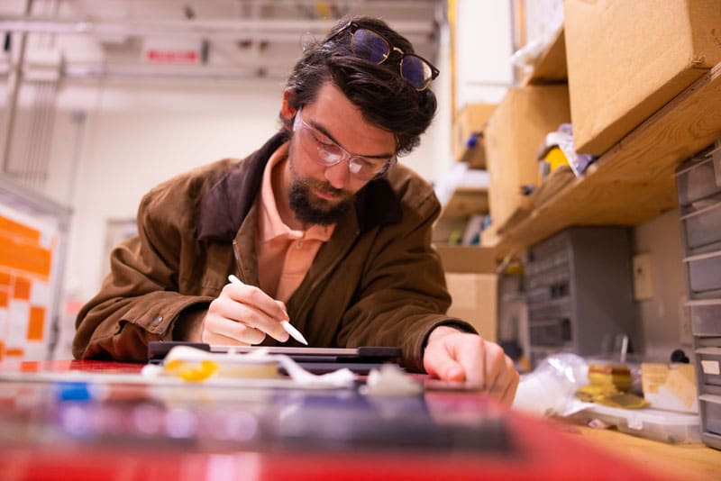 Joey Michaud works on a tablet inside a lab