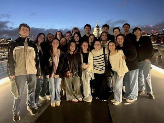 Group image of the Engineering in London students with the city behind them