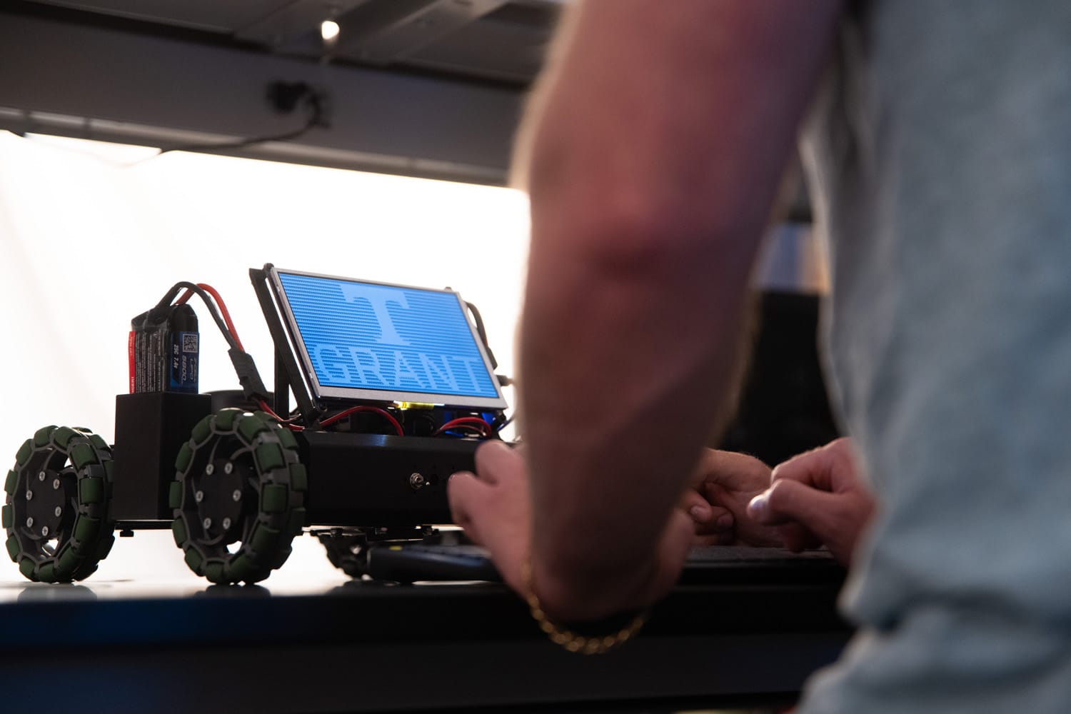 Student works with robot inside Neuromorphic Computing Lab
