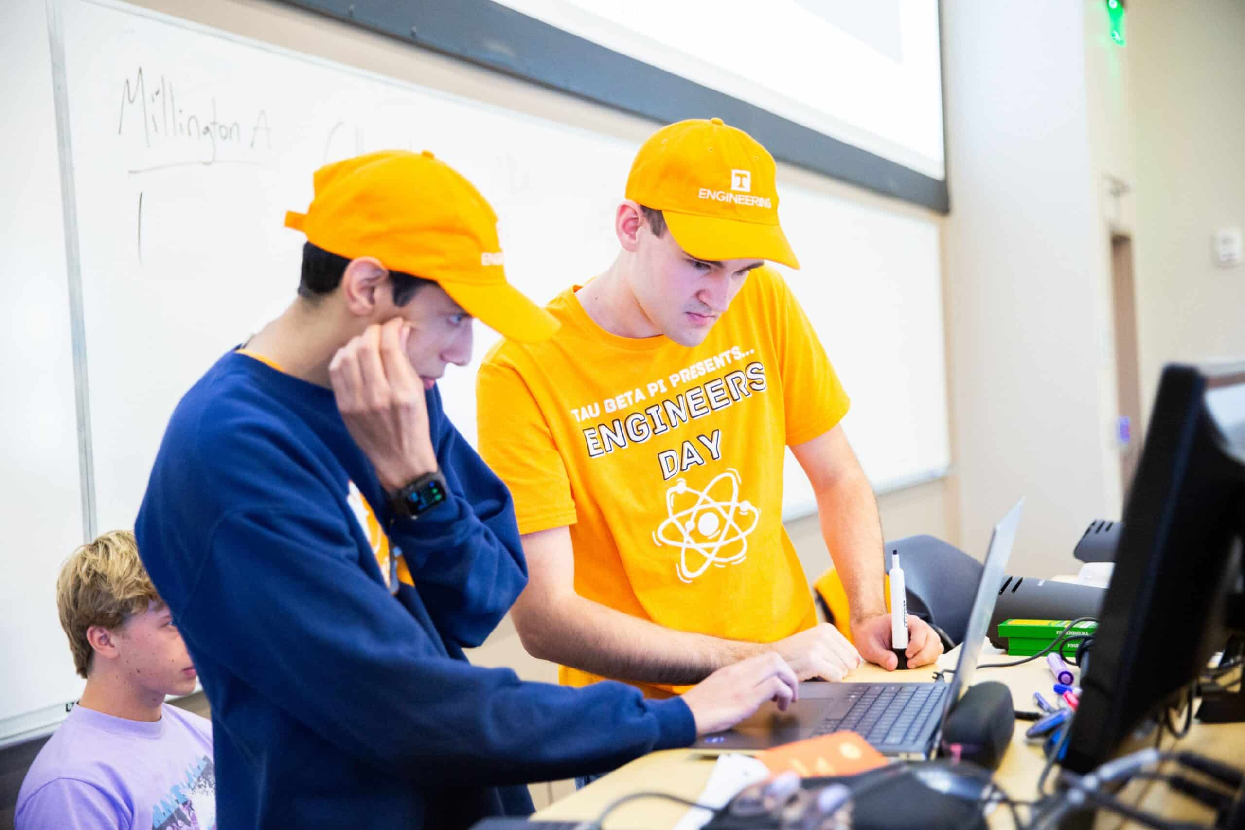 Two TCE students looking at a computer during Engineers Day