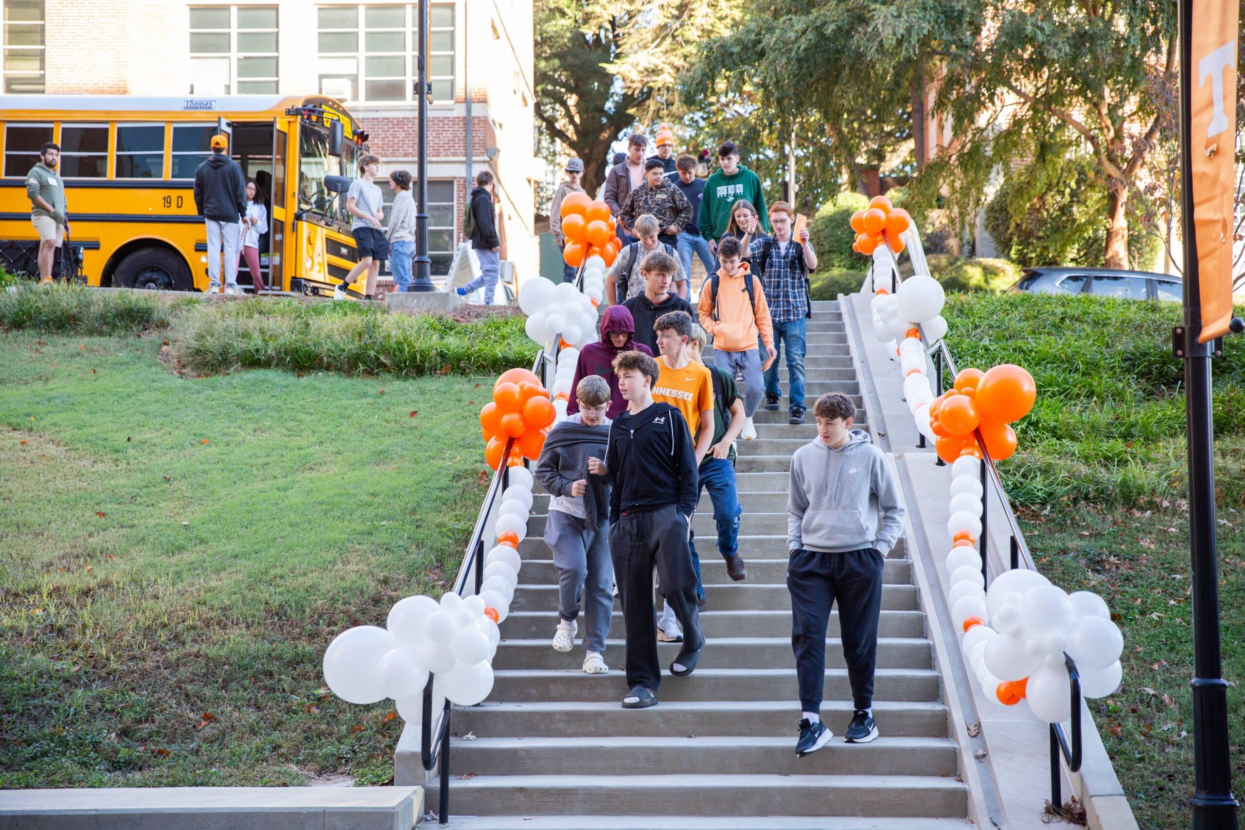 High school students walking down the stairs from the bus to Zeanah Engineering Complex