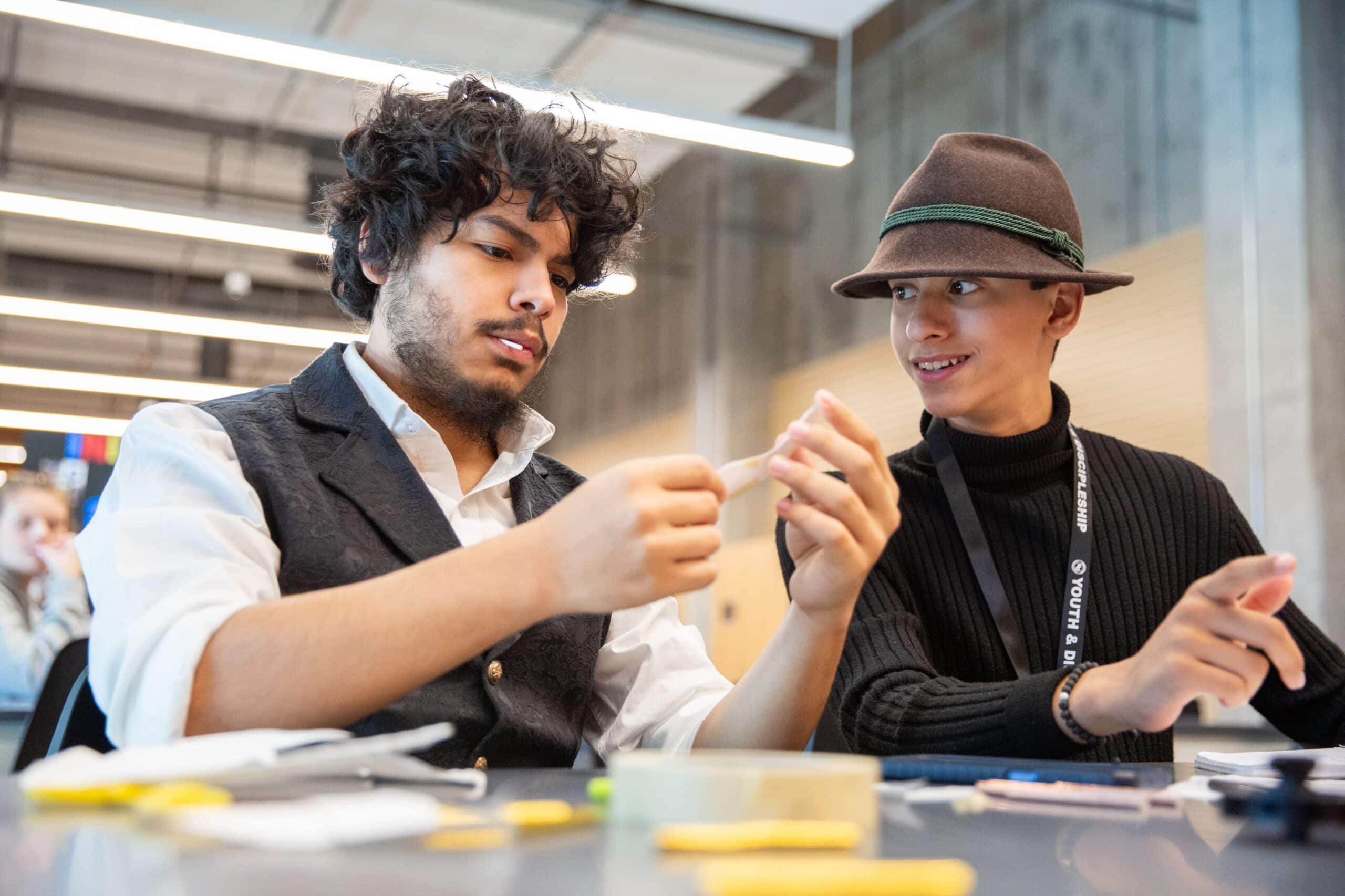 Two high school students working with putty in a makerspace 