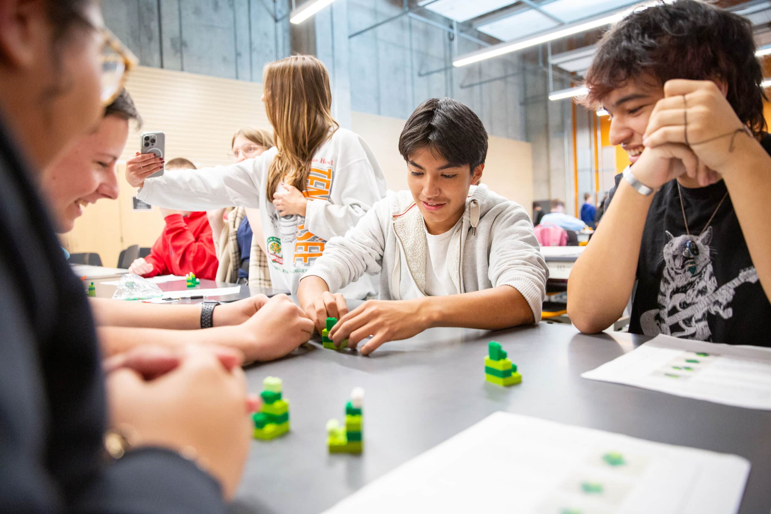 High school students working with legos in a makerspace