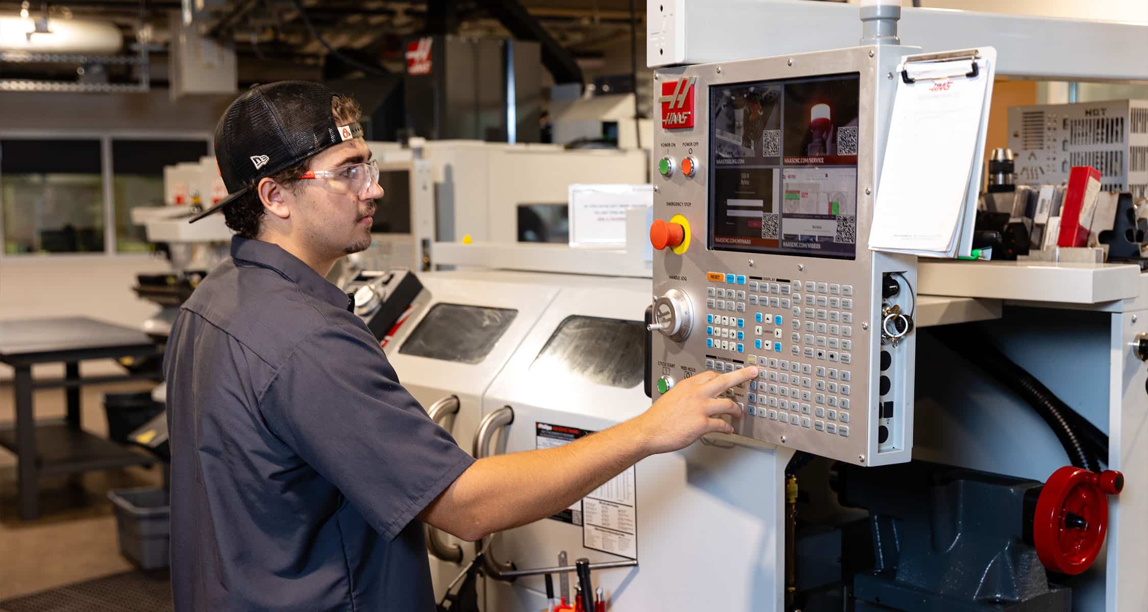 ICS student worker demonstrates the use of CNC machines in the ICS